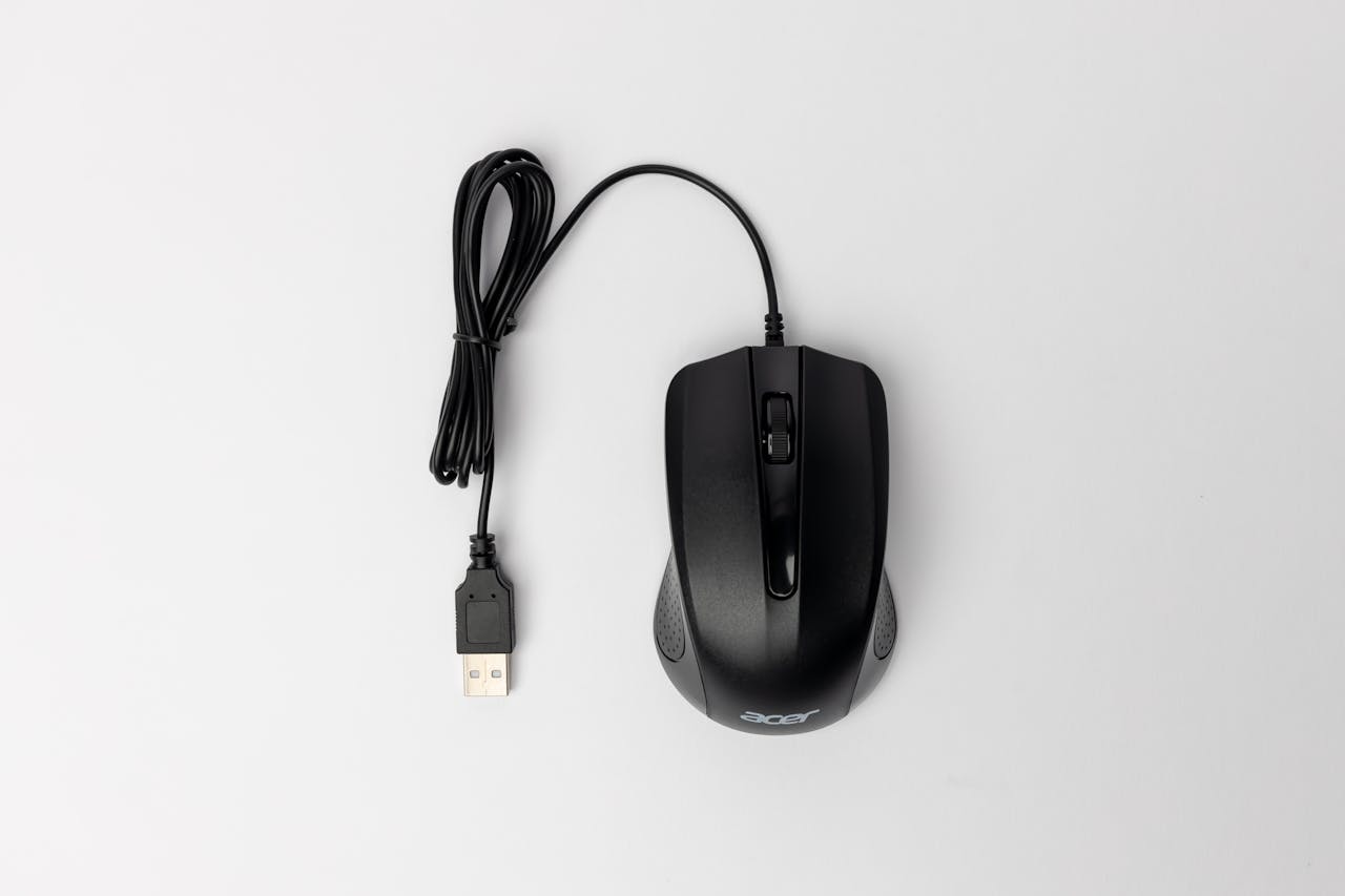 Top View of a Black Computer Mouse on White Background